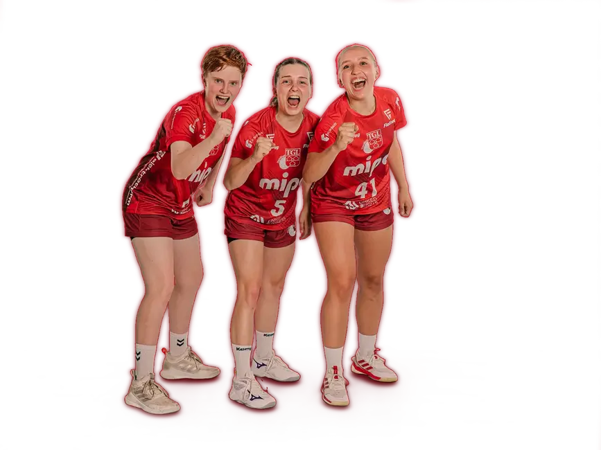 Eine fröhliche Handballmannschaft der Turngemeinde Landshut posiert in roten Trikots mit Bällen.