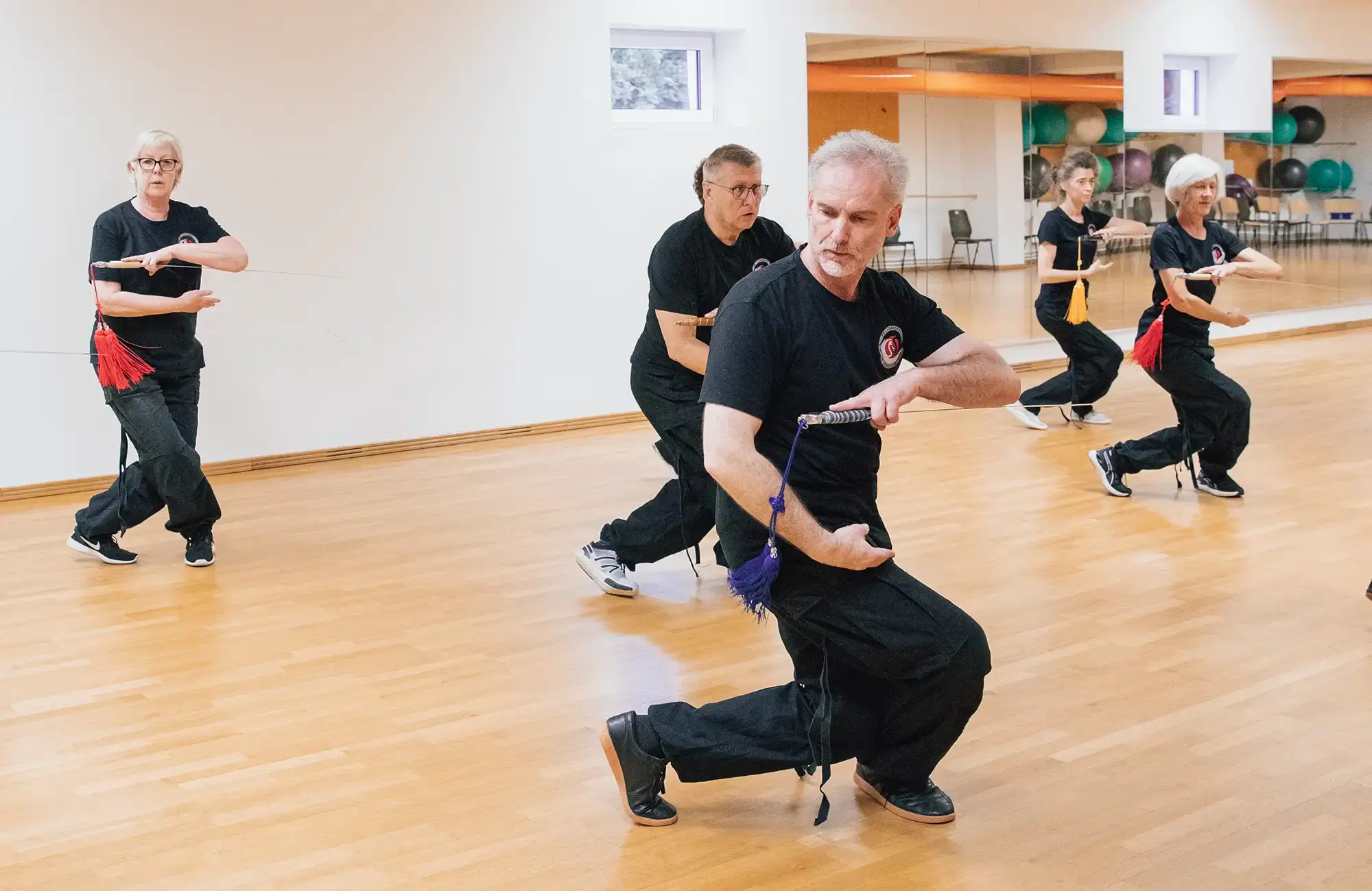 Eine Gruppe des Turnvereins Landshut übt im Trainingsraum konzentriert ihre Kampfsporttechniken.